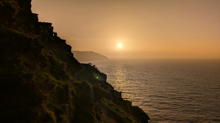 Narrow grassy path along the cliffside