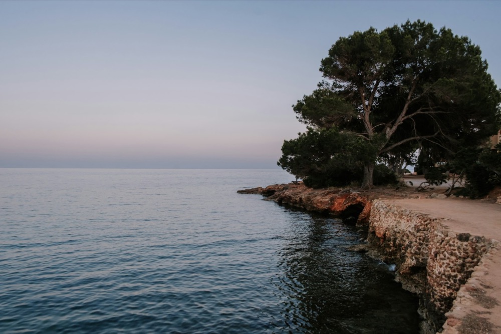 Calm sea beside a rocky shore