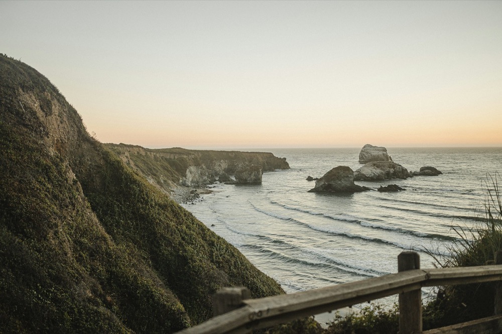 Coastal cliffs and sea stacks at sunset